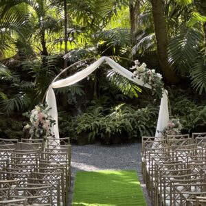 A gold cicular of an outdoor wedding ceremony space
