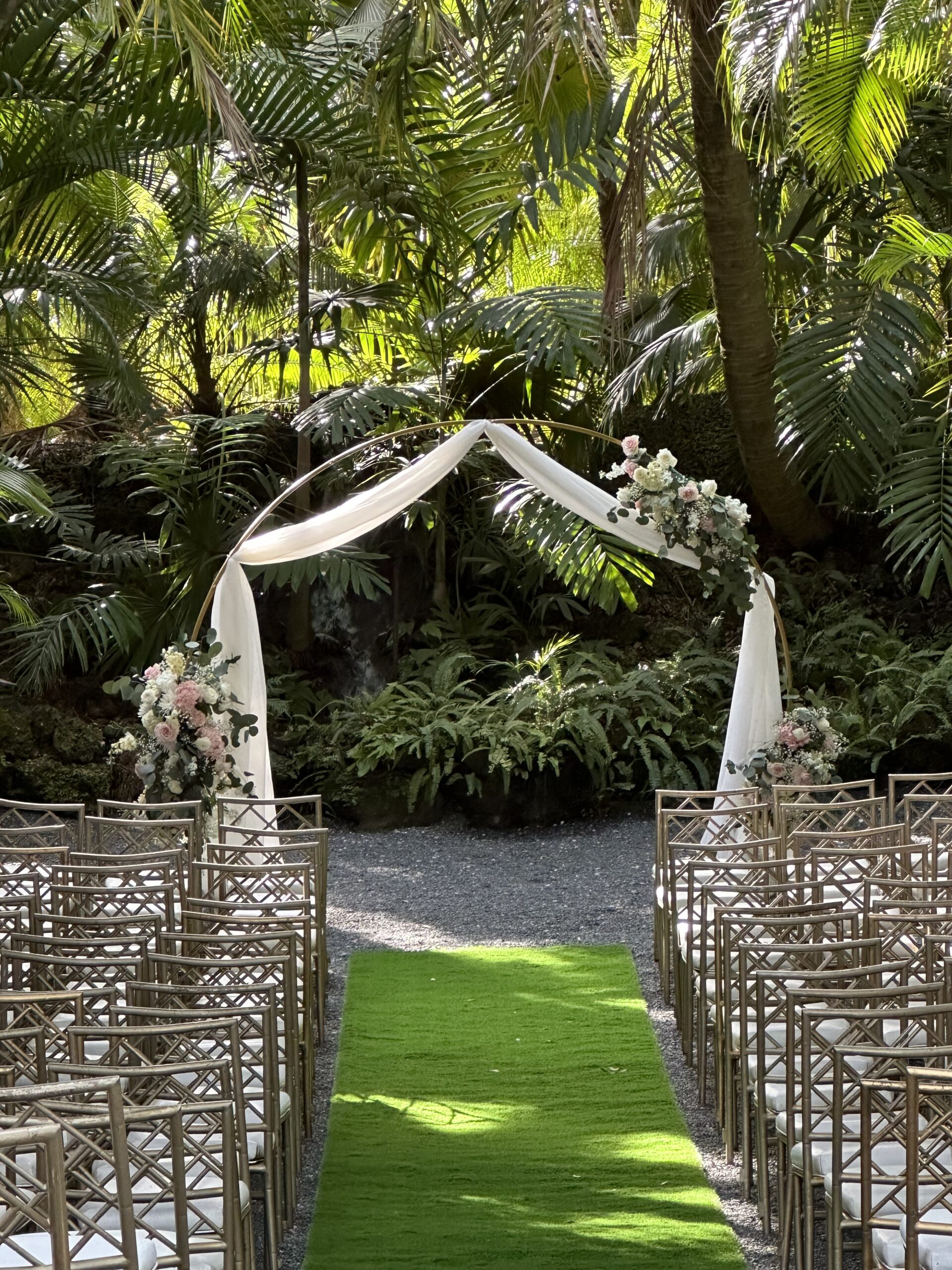 A gold cicular of an outdoor wedding ceremony space