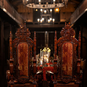 Two royal chairs with a high roof chandeleir